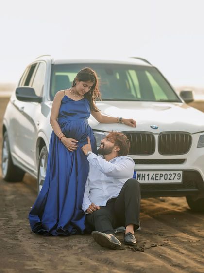 A modern and cool maternity shoot on the beach. Our simple yet elegant navy blue satin gown pairs perfectly with any casual or formal partner outfit.
