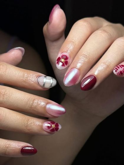 A beautiful mix of styles, including a deep red, a pearlescent cat-eye effect, and delicate hand-painted floral art.