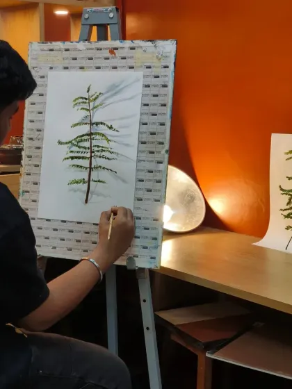 We believe in training the eye before the hand. Here, you can see our teaching method in action as a student practices live realistic painting. By carefully observing a real plant and its shadows, he learns to understand form, light, and perspective, which is the foundation of all great art.