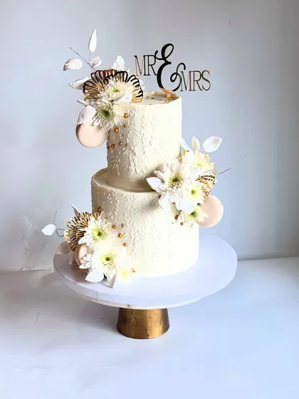 Another view of the textured white wedding cake. It's a timeless design that can be customized for weddings, engagements, or milestone anniversaries.