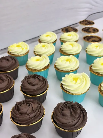 An army of deliciousness! This shot shows rows of my freshly frosted chocolate and vanilla cupcakes, ready to be boxed up for a celebration.