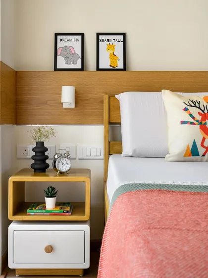 A close-up of the custom bedside table in the kids' room, featuring a unique rotatable top shelf for playful and flexible storage.