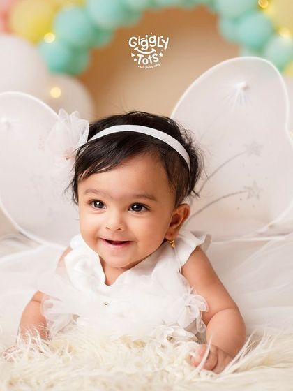 A whisper of the divine, an angelic touch. This little fairy with white wings is the picture of innocence and grace.