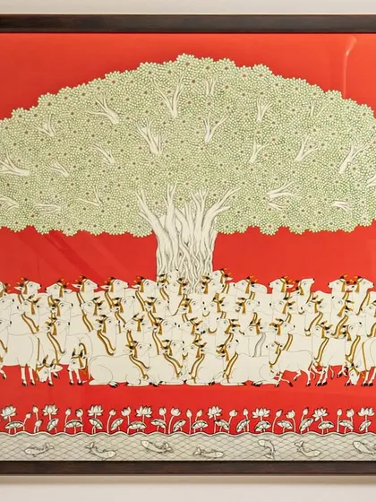 A close-up of the 'Tree of Life' artwork. This custom piece, with its intricate details and vibrant red background, serves as the heart of the dining space, symbolizing growth and harmony.