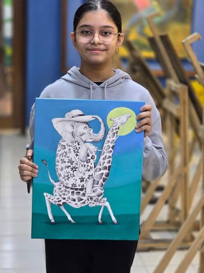 The proud artist with her finished piece. This imaginative ballpoint pen drawing is a wonderful example of the creativity we encourage in our students.