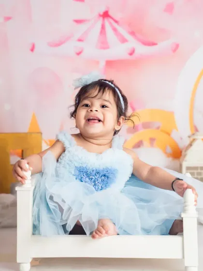 A huge, happy smile from the birthday girl. We focus on capturing genuine, unposed moments of happiness during our whimsical first birthday photoshoots.