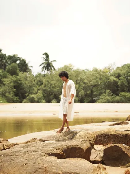 This series showcases a male model interacting with the natural beach environment. From the water to the rocks, each shot captures a different mood, perfect for an editorial story.