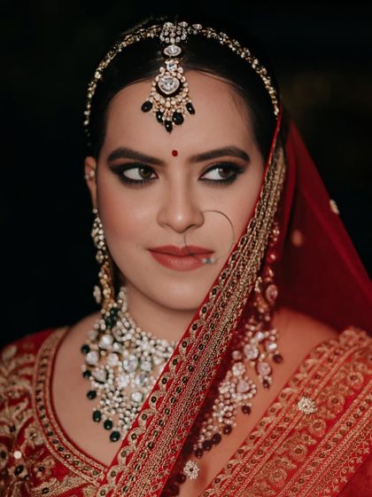 A close-up portrait focusing on the bold, smokey eyes and the perfectly placed matha patti.