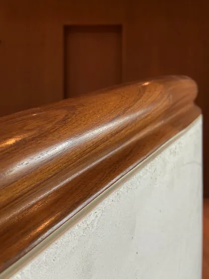 A detail of the solid teak wood railing, moulded to curve along the winding staircase at the Worli duplex. This showcases our commitment to high-quality materials and bespoke craftsmanship.