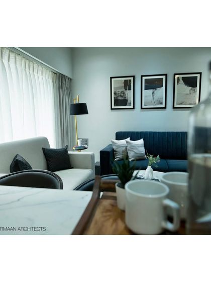 A view from the breakfast counter into the living room at Tulsi Heights. This perspective highlights the open layout we created, allowing for easy conversation and connection between the kitchen and living areas.