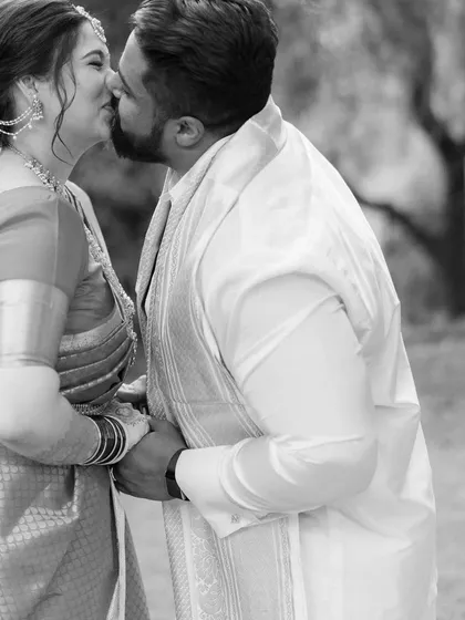 A quiet, intimate kiss shared between Gayatri and Akash. This black and white portrait strips away all distractions, focusing solely on the couple's connection and the emotion of the moment.