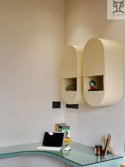 Detail of the pill-shaped wall cabinets. Their rounded form adds a soft, modern touch, and the open niche is perfect for displaying small, personal items, making the workspace feel more personalized.