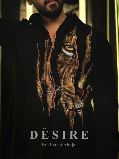 A close-up of the tiger-print shirt, showcasing the intense, artistic detail of the design.