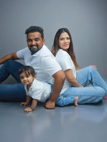 Let's have fun! Family sessions with me are relaxed and playful. I encourage the giggles, the silly faces, and the candid interactions, just like this moment of a family in matching white tees and jeans.