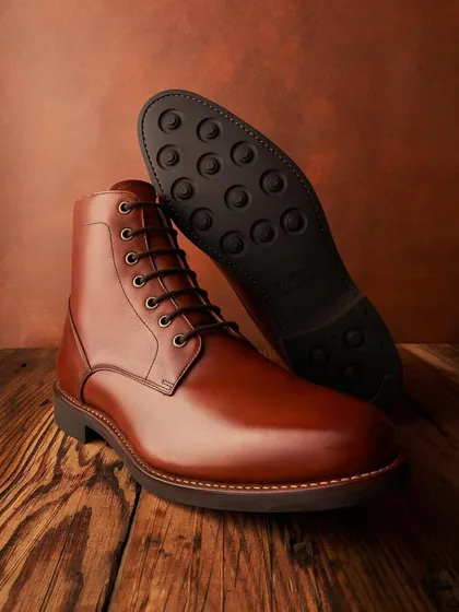 The best kicks are made of leather. This shot for Hanker Boots shows off the rich color and shine of the leather, as well as the sturdy sole. The warm, textured background adds to the heritage feel.
