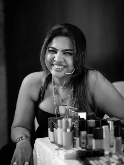 A smile of satisfaction after a successful session. Behind me is my kit, filled with the products I trust and teach you about, focusing on what works best for Indian skin tones and conditions.