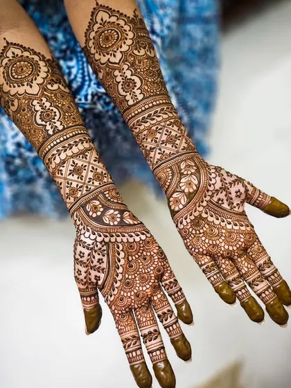 The full two-arm view, showing how the patterns create a balanced and complete bridal look.