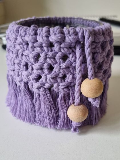 The purple jar cover, shown here without a light, highlighting the net-like pattern and beaded tassels.