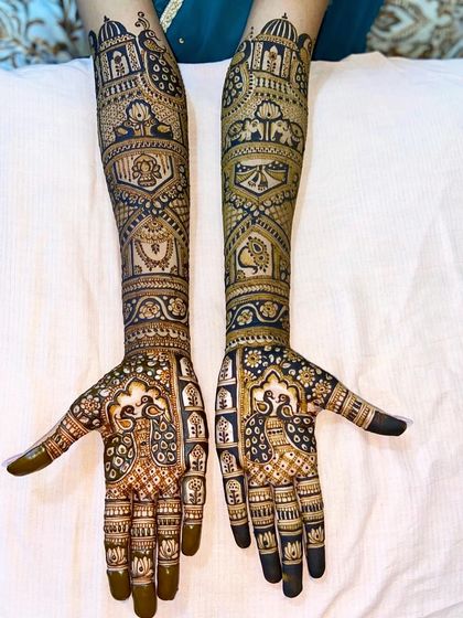 A rich and dark-stained traditional design featuring palace architecture, elephants, and peacocks. This is a classic choice for a royal bridal look.