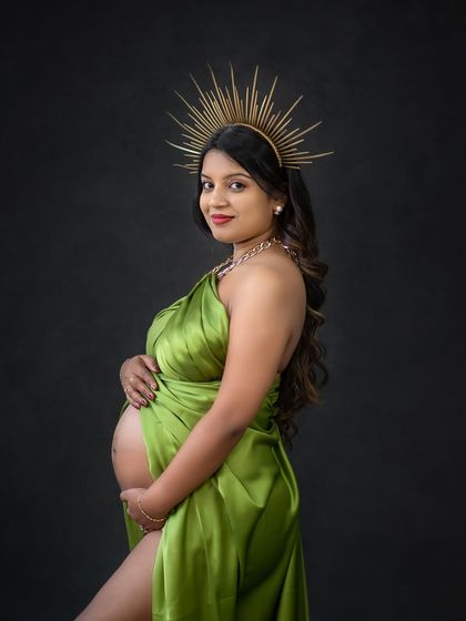 A close-up portrait from the goddess shoot, showcasing the stunning headpiece and the confident expression of the expecting mother.