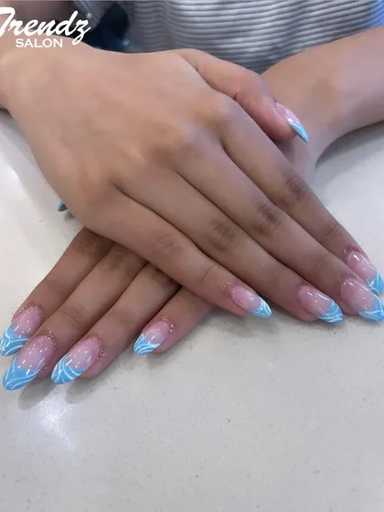Here is a playful and colorful French manicure. I used a bright sky blue for the tips and added a delicate white swirl pattern, creating a fun and eye-catching design perfect for summer.