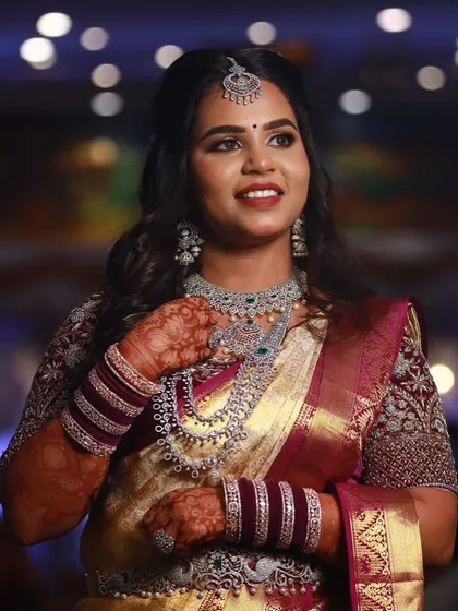 A full portrait of the bride at her reception, her stunning saree and jewelry complemented by her beautiful mehendi.