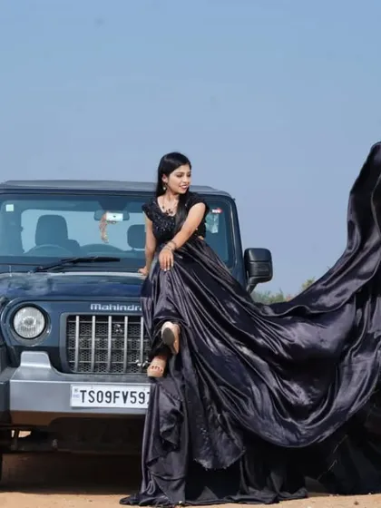 Who says fairytales can't be edgy? This dramatic black infinity gown creates a powerful, flowing silhouette against the rugged backdrop, proving that your love story can be both romantic and bold.