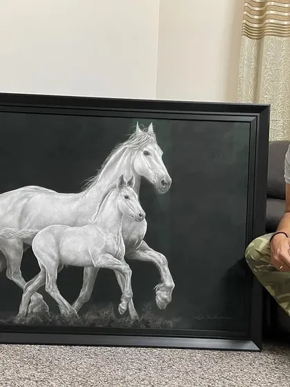 The finished 'Equine Companions' artwork, framed and resting in my studio. This gives a sense of the final product's scale and finish.
