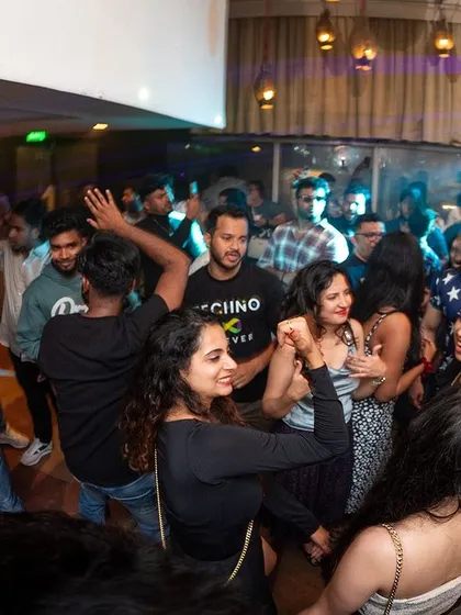 A wide angle shot of the dance floor at i-Bar, showing a mix of people dancing and socializing.