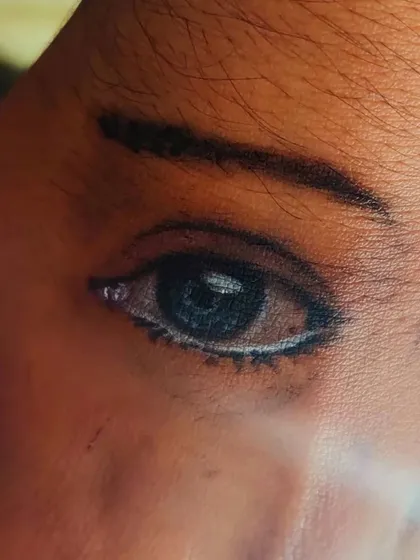 A close-up of the incredible eye painting on our instructor's hand, showcasing the amazing realism that can be achieved with the right techniques.