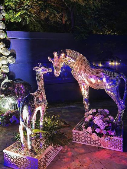 The family of glittering animals, including giraffes and an elephant, creating a unique and playful decor theme.