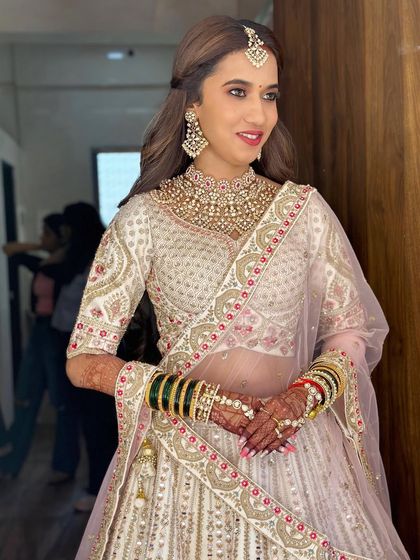 A beautiful portrait of the bride, showcasing her radiant smile and the flawless finish of her makeup.
