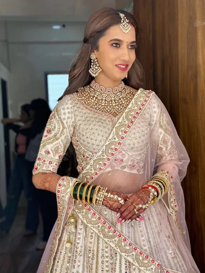 A beautiful portrait of the bride, showcasing her radiant smile and the flawless finish of her makeup.