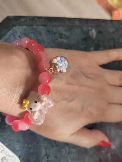 For the young at heart, this cute Hello Kitty charm bracelet is a fun and playful accessory. The pink beads and whimsical charms make it a sweet addition to a casual outfit.