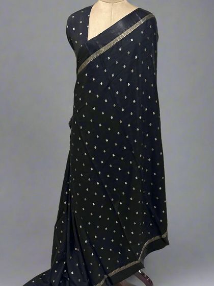 A plain black Chinnon saree with a simple satin border.
