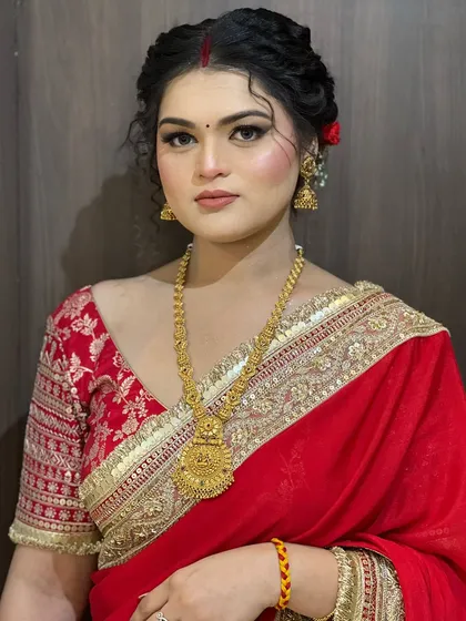 A full portrait of the client, looking poised and elegant in her traditional attire.