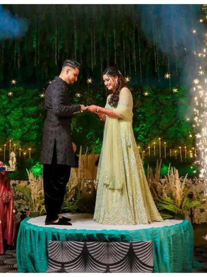 Dreamy and distinct. Our client stands out in a black Sherwani set with an off-centre placket, a modern touch to a timeless ensemble.