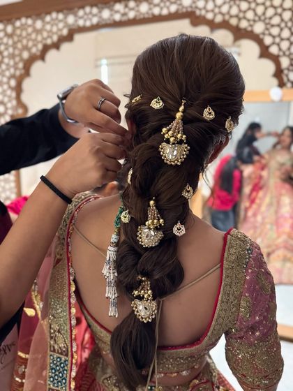 A behind-the-scenes look at the final touches being put on this intricate, accessorized bridal braid.