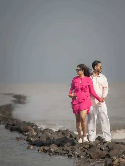 A beautiful maternity pre-wedding shoot on the rocks by the sea. This photo captures the couple's excitement and love as they await their new arrival.