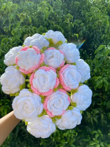 A beautiful bouquet of white roses with delicate pink edges.