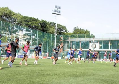 A dynamic shot of footballers sprinting during a training session. This image conveys the speed and power that our programs are designed to develop, preparing athletes for the highest levels of competition.