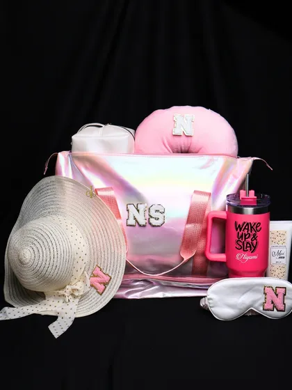 Our complete holographic travel set in pink. This collection includes a personalized duffle bag, neck pillow, eye mask, tumbler, and a matching sun hat.