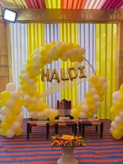 A budget-friendly Haldi setup using a balloon arch and simple seating, proving that you don't need to spend a lot to have a beautiful ceremony.