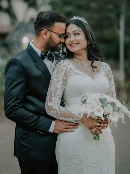A tender and romantic portrait of the couple, holding each other close. The bride's beautiful bouquet adds a touch of elegance.