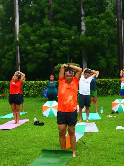 A group of members performing a tricep stretch during our outdoor yoga session. We always incorporate proper cool-downs to prevent soreness.
