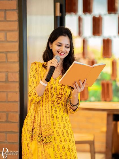 A smiling poet reads from her book. The theme of "Vulnerabilities" brought out some of the most authentic performances.