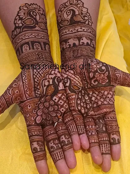 This design is filled with peacocks and elephants, two of the most beloved motifs in Indian bridal mehendi.