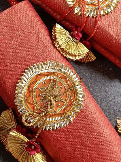 Two of our ornate wedding scrolls, tied with traditional tassels. The rich red paper and gold embellishments give them a regal and festive look.