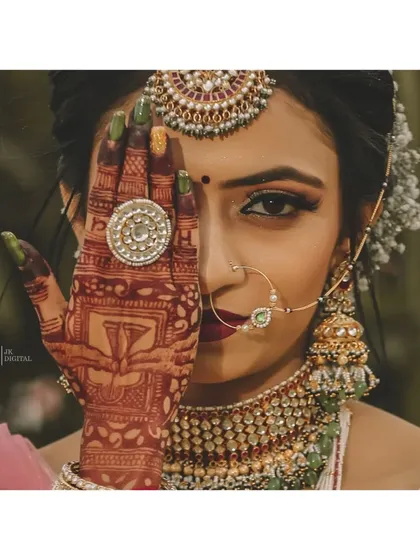 It's all in the details. This bridal portrait focuses on the intricate mehendi design, the stunning jewelry, and the quiet confidence of the bride, preserving the artistry of her wedding look.