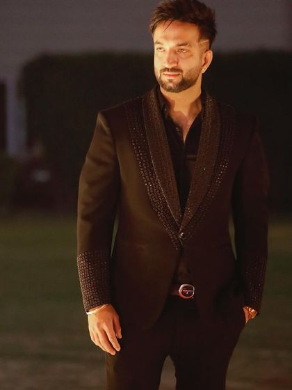 The same black beaded tuxedo, captured in an outdoor setting. It's a versatile piece that looks great in any environment.
